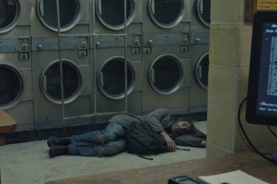 “Got a vagrant sleeping by the dryers, send someone to move him along,” the dispatcher said, and I barely looked up because loitering calls were the easiest part of my shift…